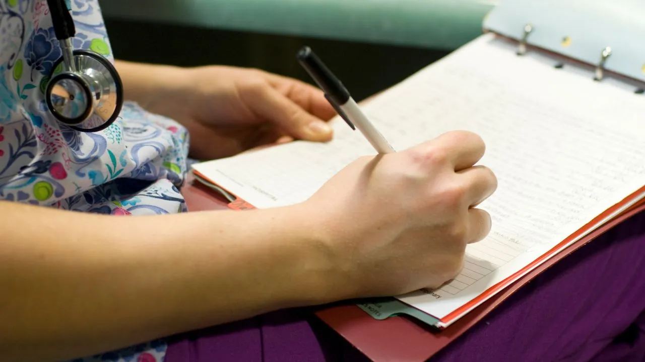 nurse using paper charting due to tech outages